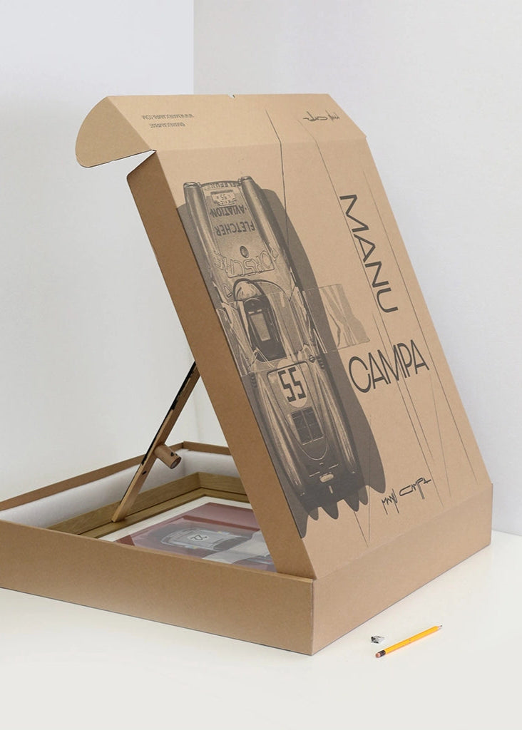 Manu Campa art print packaging box with automotive artwork, showing protective cardboard case and framed print inside